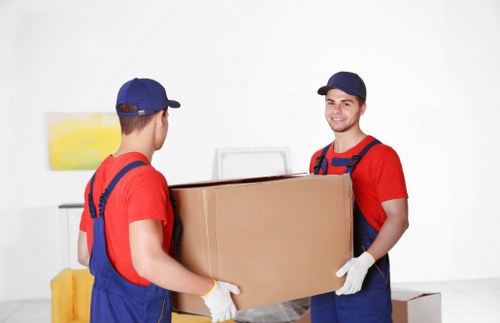 Furniture removal team handling a move in a Soho street