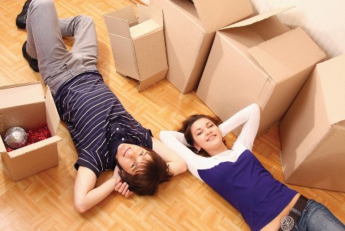 Removalists handling furniture protection and stair access during a Soho move